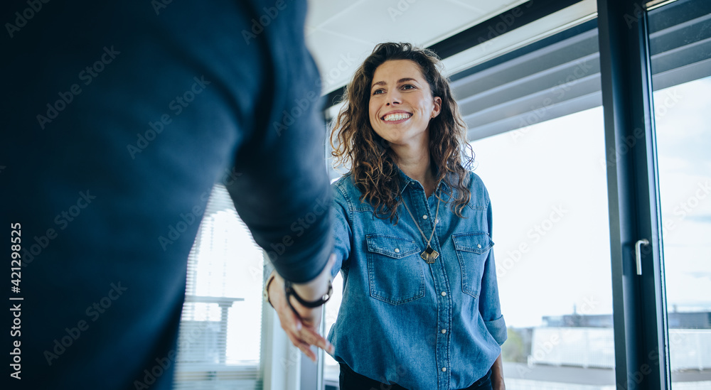 Employer shaking hands with job candidate
