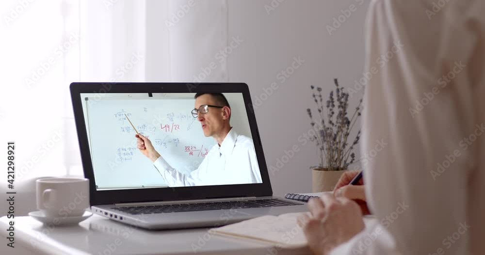Distance learning. A male teacher at the laptop screen conducts an online lesson. Distance learning. A male teacher at the laptop screen conducts an online lesson.