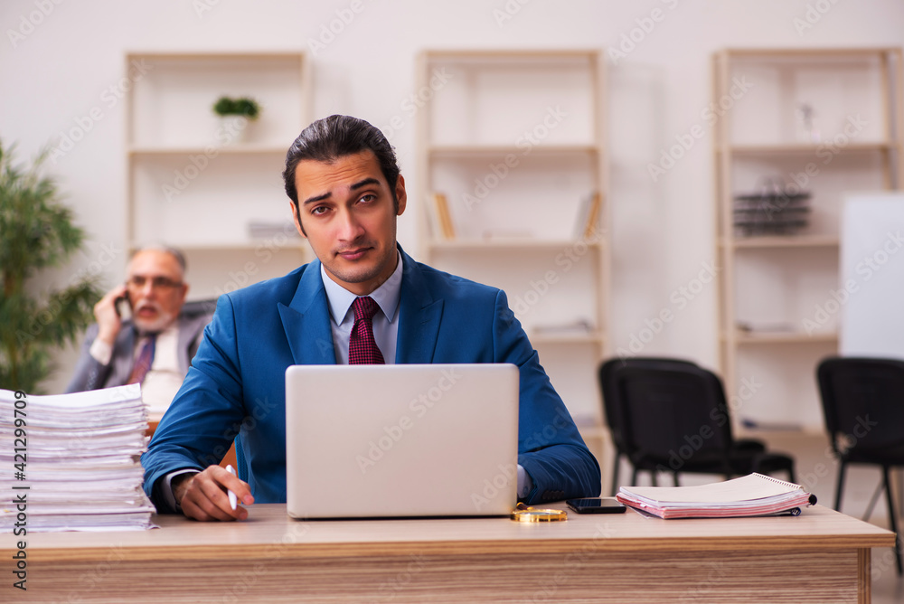 Two employees working in the office Two employees working in the office