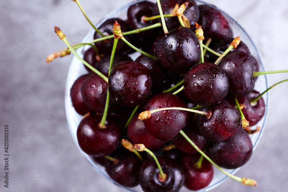 Fresh cherries in glass on a dark background. Top view Fresh cherries in glass on a dark background. Top view