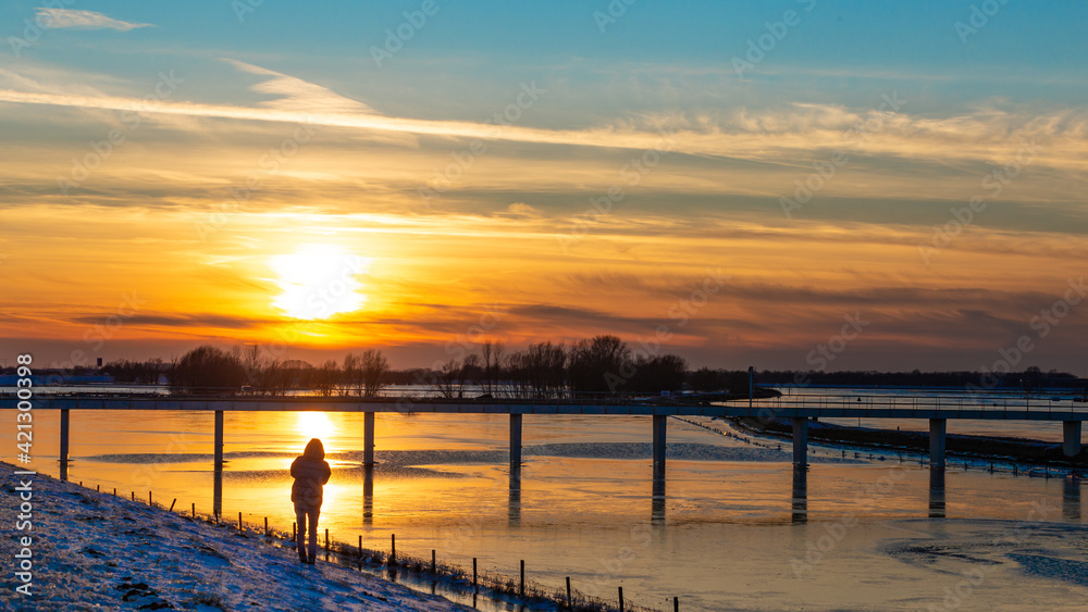 Sunset landscape with frozen floodplains in The Netherlands