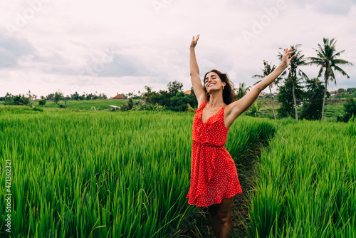 Happy woman walking in green field