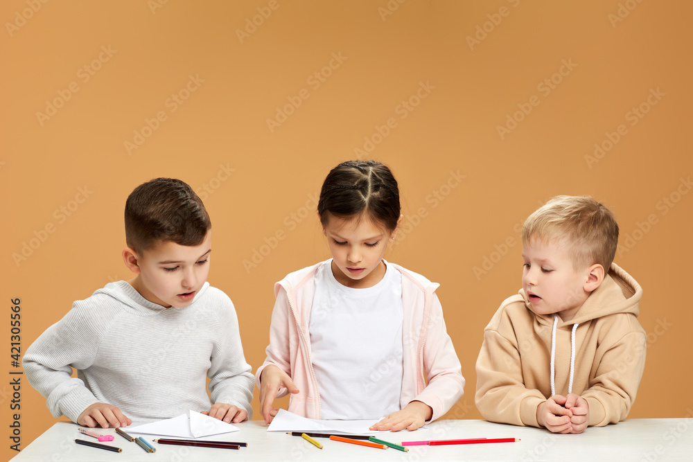 happy children draw together at the table happy children draw together at the table