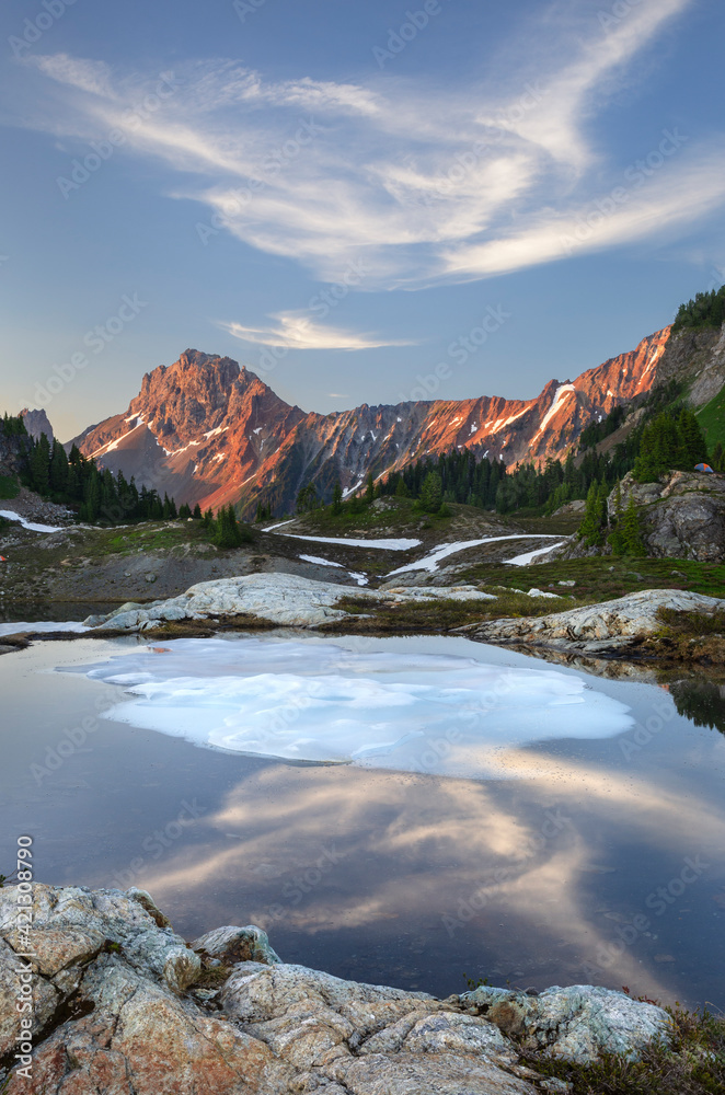 Partially thawed tarn, Yellow Aster Butte Basin. American Border Peak and Yellow Aster Butte in the distance. Mount Baker Wilderness, North Cascades, Washington State