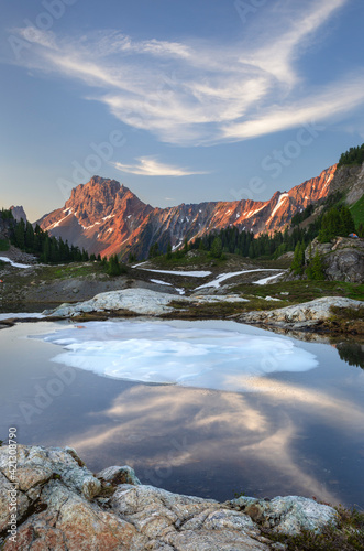 Partially thawed tarn, Yellow Aster Butte Basin. American Border Peak and Yellow Aster Butte in the distance. Mount Baker Wilderness, North Cascades, Washington State