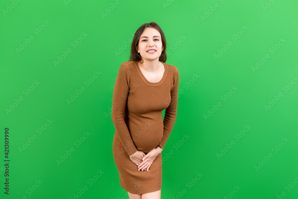 urinary incontinence during pregnancy. Abdominal pain during pregnancy. Maternity healthcare concept on colored background urinary incontinence during pregnancy. Abdominal pain during pregnancy. Maternity healthcare concept on colored background