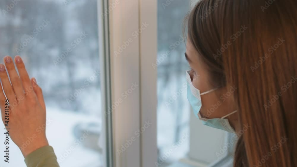 Woman in Quarantine Looking out the Window. Staying Home in Self-Quarantine. Woman in Quarantine Looking out the Window. Staying Home in Self-Quarantine.