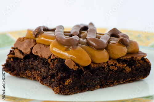 Chocolate brownie topped with caramel and hazelnut spread close up