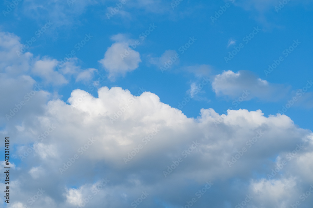 Bright blue sky with white fluffy clouds and bright sunlight. Bright blue sky with white fluffy clouds and bright sunlight.