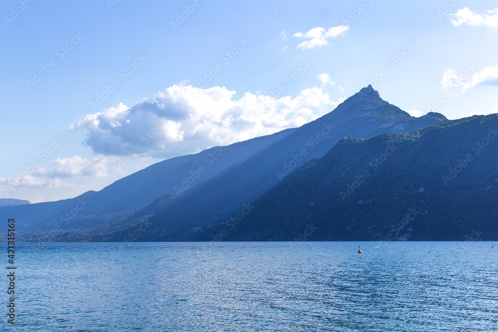Water and mountain panorama summer view of Mont Dent du Chat on Lake Bourget Aix les bains town Auvergne-Rhône-Alpes region France 