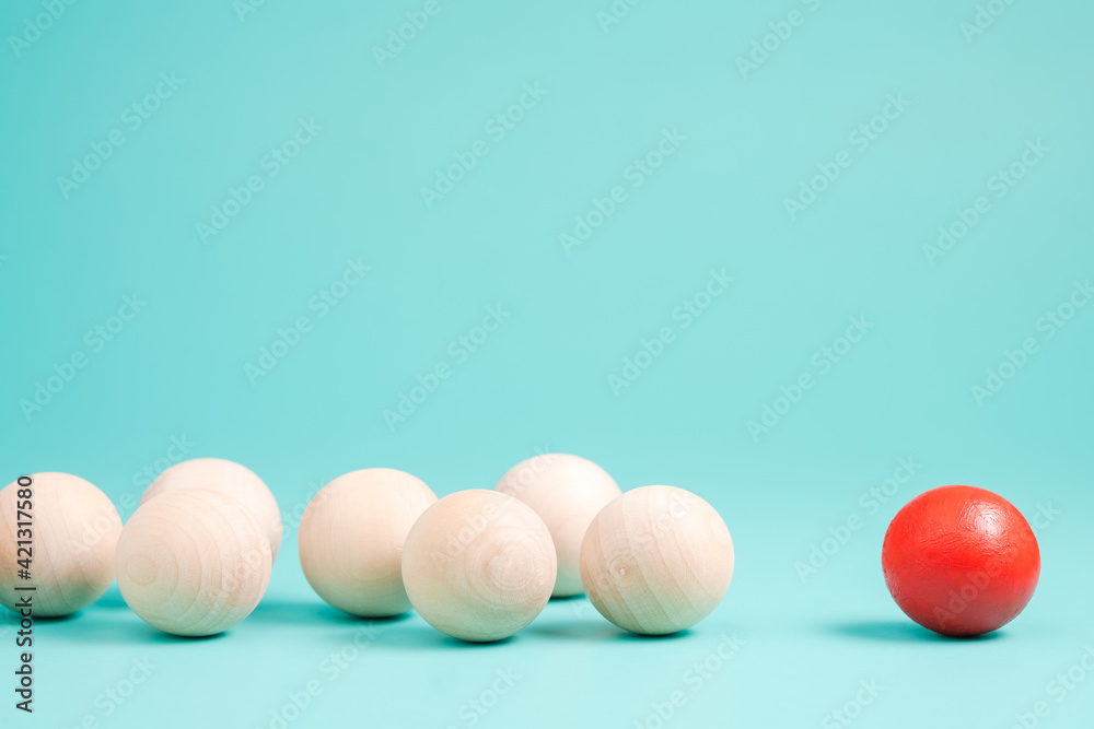 Small Wooden Ball and the Red One, influencer and follower, brand and marketing concept Small Wooden Ball and the Red One, influencer and follower, brand and marketing concept