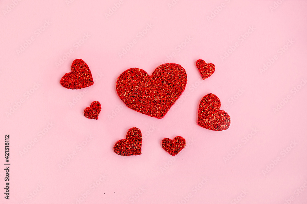 Love theme background with red glitter handmade hearts on pink background. Romantic concept
