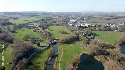 Idyllic green British Canterbury countryside aerial view pull back above River Stour Chartham village scenery photo