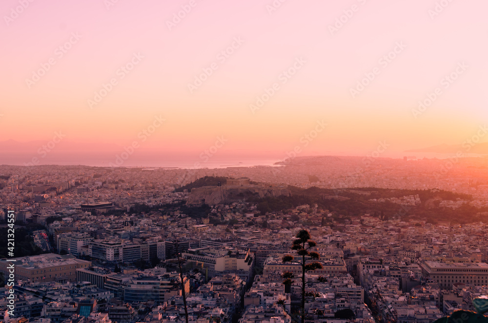 View of sunset from mount Lycabettus in Athens, Greece, in the distance Acropolis and Saronic Gulf