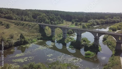 Beautiful railway bridge viaduct over river Sluch, Novograd Volynsky, Ukraine photo