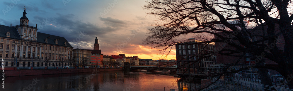 beautiful sunset over the river and the old city of wroclaw in poland