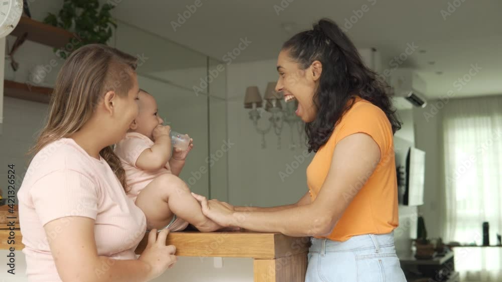 lesbian mother playing with peekaboo with baby in the kitchen
lesbian mother playing with peekaboo with baby in the kitchen