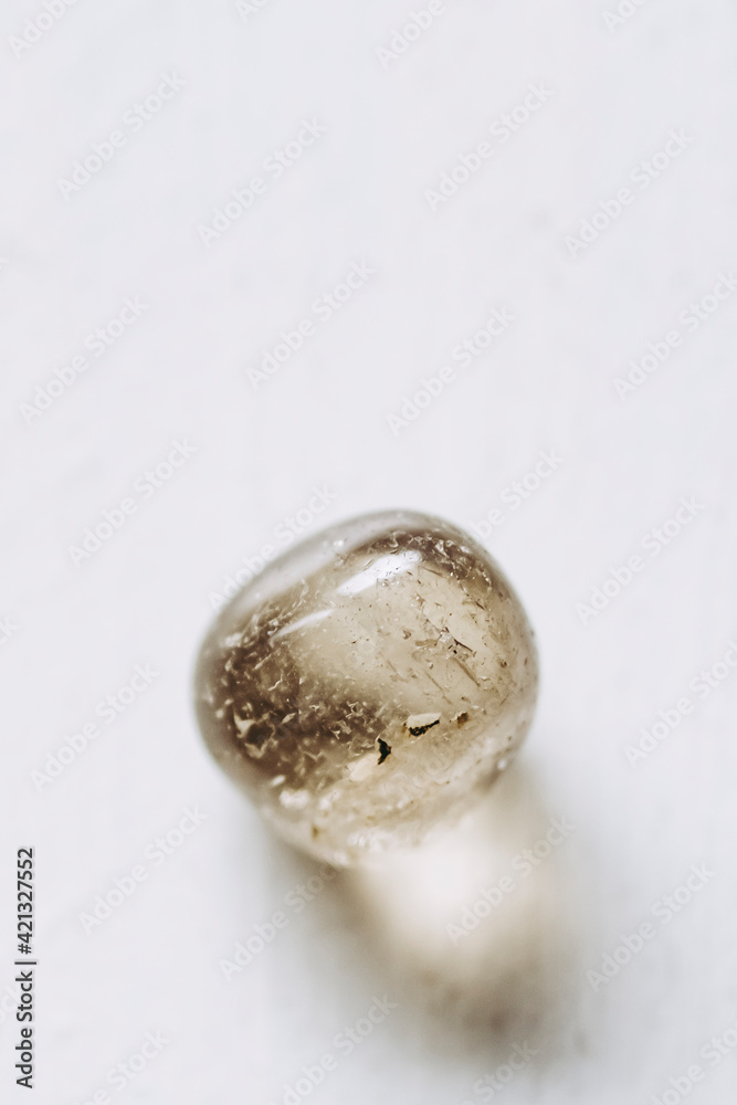 Pierre polie quartz fumé sur un fond blanc Pierre polie quartz fumé sur un fond blanc