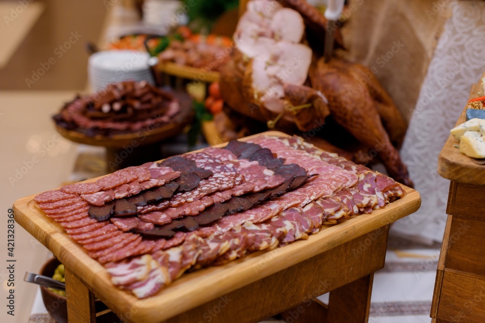 Close up view of serving wooden desk with various meat food on the party. Close up view of serving wooden desk with various meat food on the party.