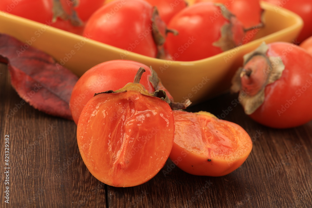  Japanese Fuyu Persimmon on wooden background 