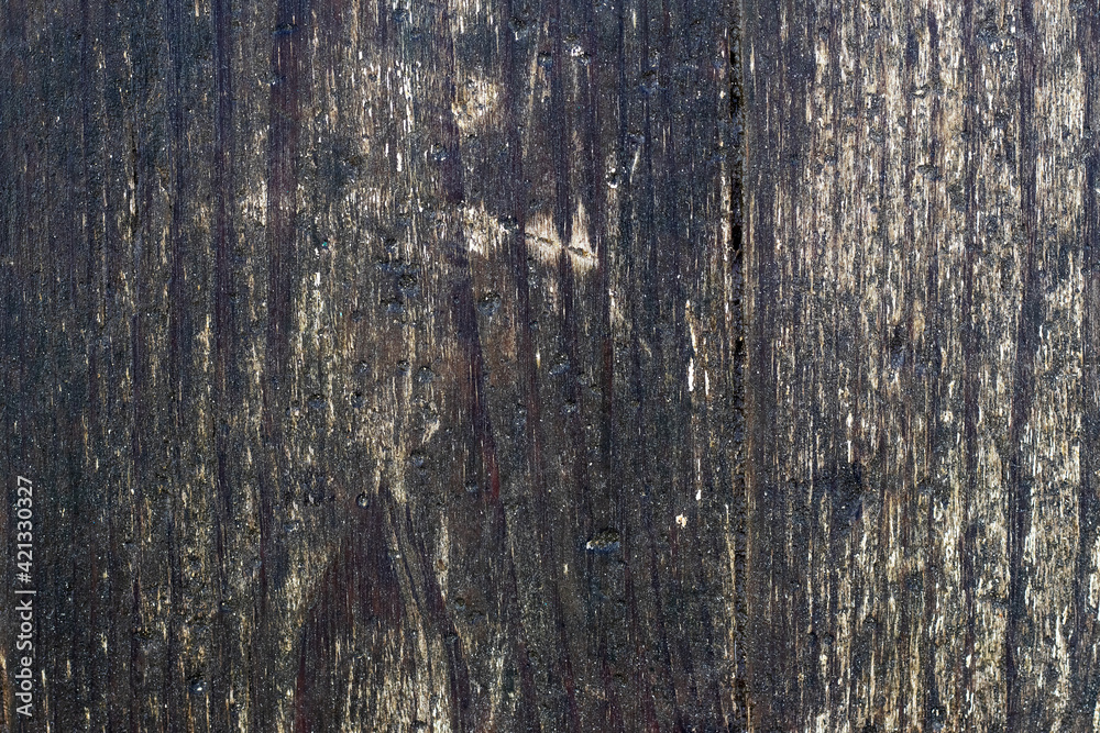 Dark wooden background with old boards with traces of white peeling paint Dark wooden background with old boards with traces of white peeling paint