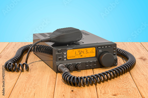 Amateur radio transceiver with push-to-talk microphone switch on the wooden planks, 3D rendering photo