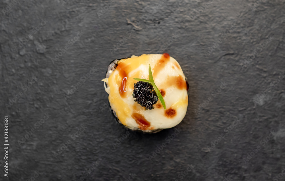 one sushi roll on a stone background one sushi roll on a stone background