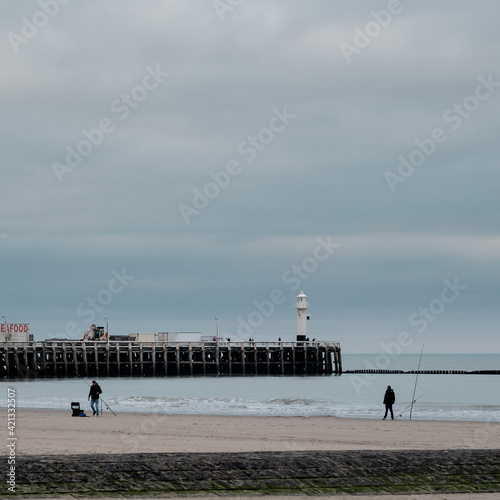 Old wooden pier of Blankenberge in Belgium against grey sky. photo