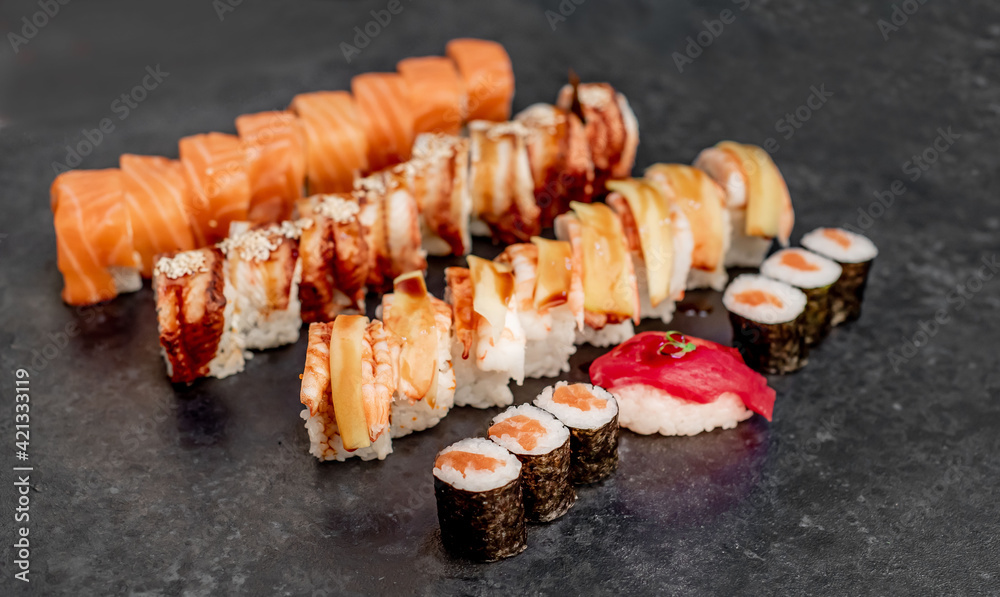Assorted sushi. set of sushi rolls and nigiri on a stone background Assorted sushi. set of sushi rolls and nigiri on a stone background