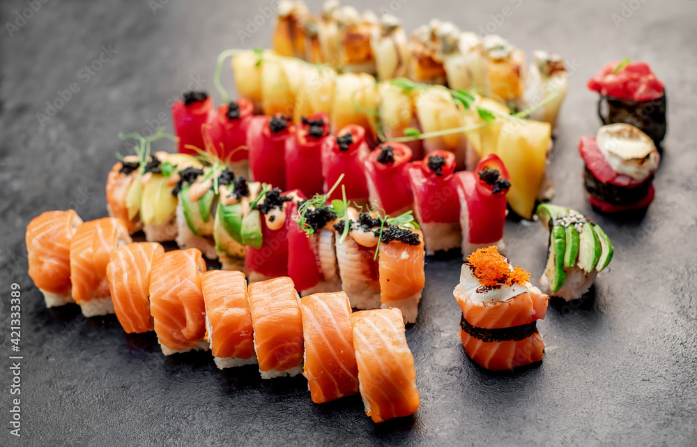 Assorted sushi. set of sushi rolls and nigiri on a stone background Assorted sushi. set of sushi rolls and nigiri on a stone background