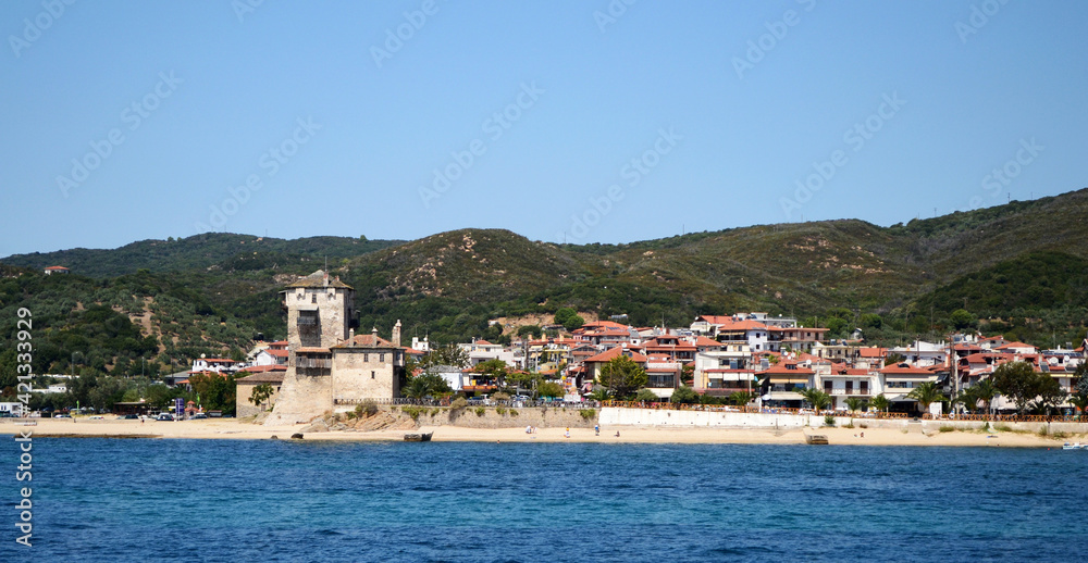 Landscape of the town Ouranoupolis with the byzantine tower Prosforio, near Mount Athos, Halkidiki, Greece.