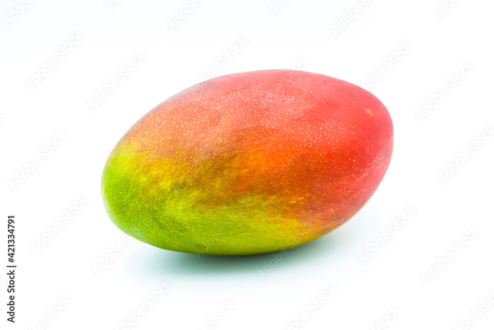 Whole mango fruit isolated on a white background. Fropical addition to slimming diets and a great natural snack. Whole mango fruit isolated on a white background. Fropical addition to slimming diets and a great natural snack.