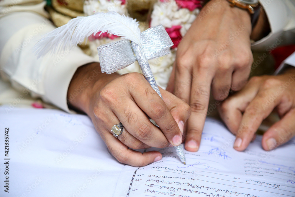 Muslim Groom Signing his Nikah Nama, Marriage License Stock Photo | Adobe  Stock