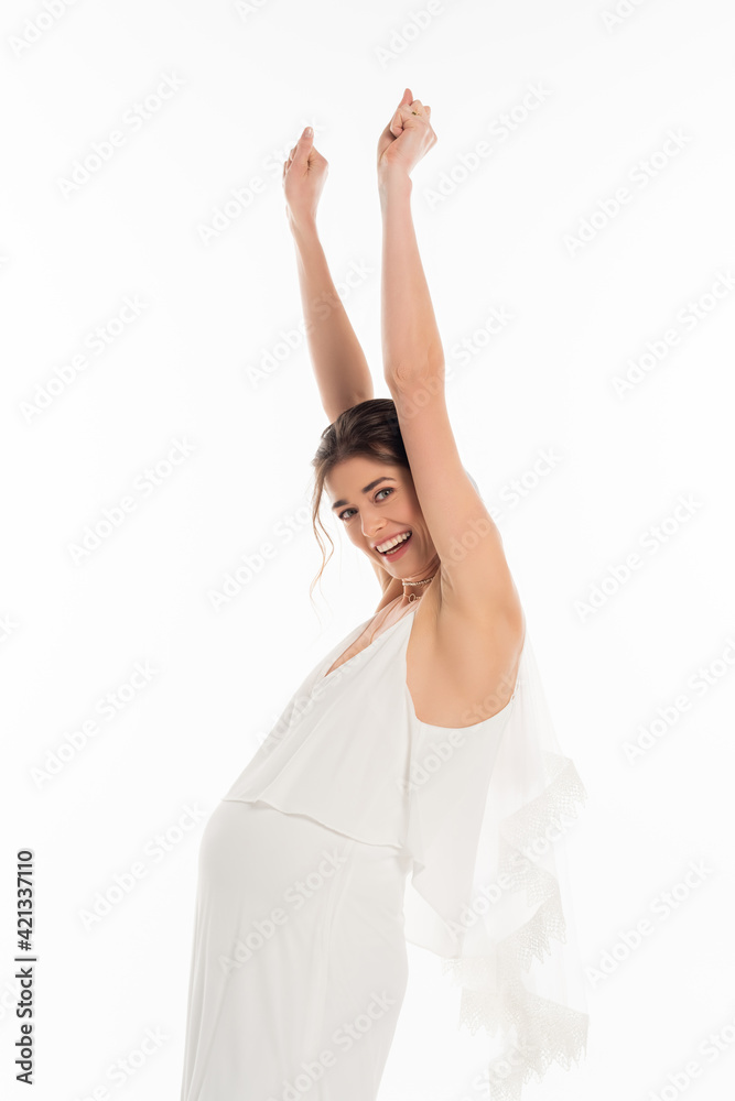 excited, pregnant bride looking at camera while standing with raised hands isolated on white excited, pregnant bride looking at camera while standing with raised hands isolated on white
