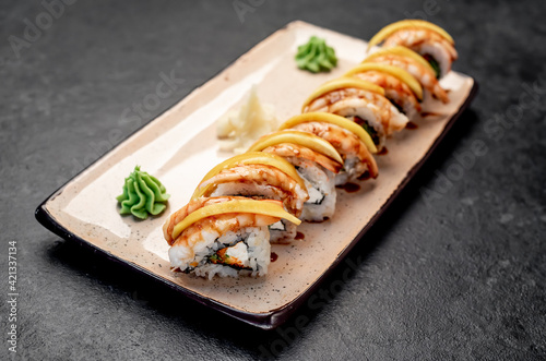 Japanese sushi rolls on a stone background 