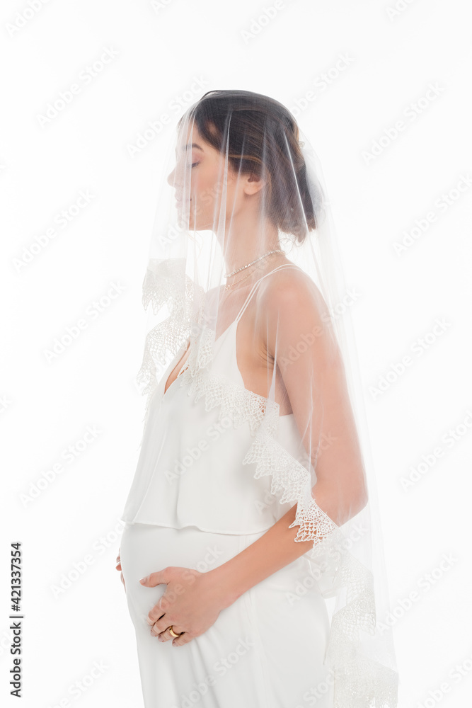 pregnant woman in wedding dress and veil standing with closed eyes isolated on white pregnant woman in wedding dress and veil standing with closed eyes isolated on white