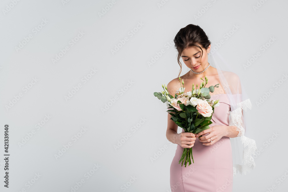 young, sensual woman in elegant dress holding wedding bouquet isolated on grey young, sensual woman in elegant dress holding wedding bouquet isolated on grey