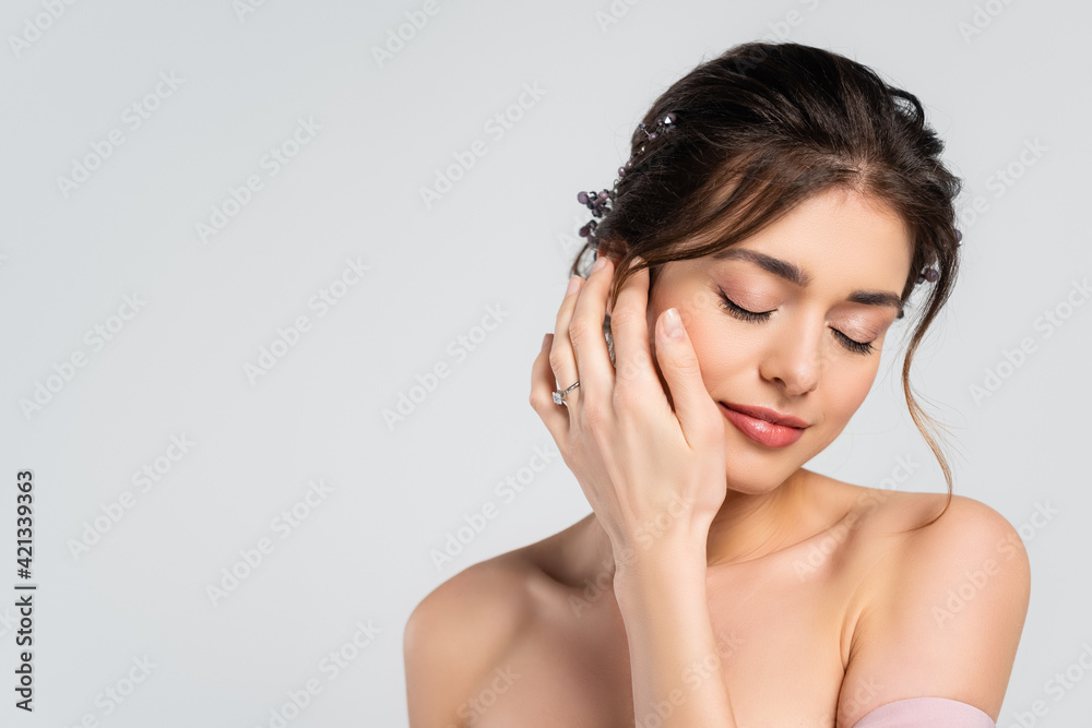 sensual bride holding hand near face while posing with closed eyes isolated on grey sensual bride holding hand near face while posing with closed eyes isolated on grey