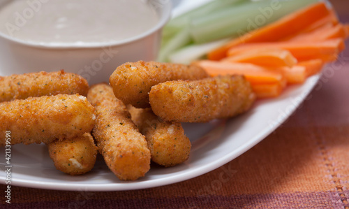 Cheese sticks on a plate with fresh veggies