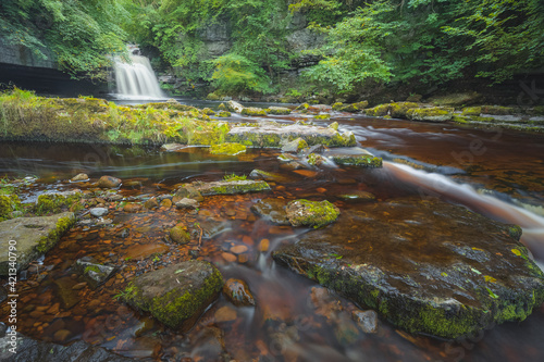 Beautiful nature waterfall scenery in a woodland forest at West Burton Falls or Cauldron Falls in Wensleydale of the Yorkshire Dales National Park, England, UK. photo