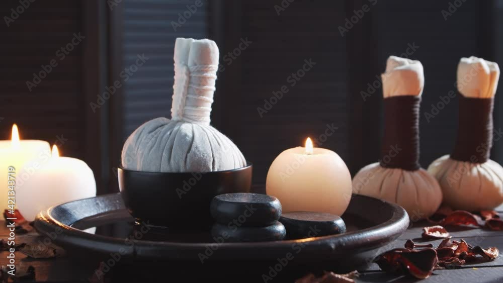 Spa background. Candles, massaging stones and herbal balls. Massage, oriental therapy, wellbeing and meditation.
