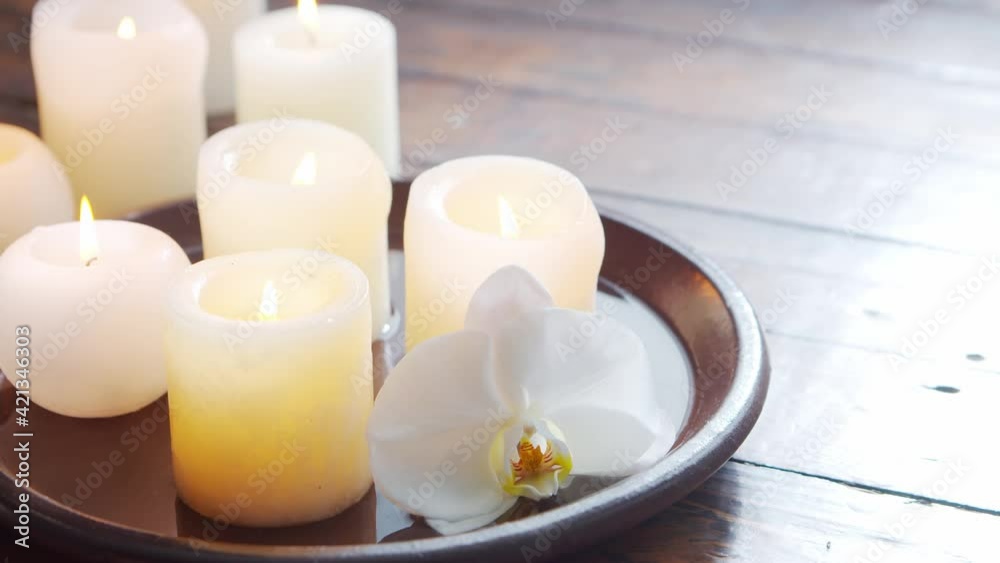 Spa background. Towel, candles, flowers, massaging stones and herbal balls. Massage, oriental therapy, wellbeing and meditation. Spa background. Towel, candles, flowers, massaging stones and herbal balls. Massage, oriental therapy, wellbeing and meditation.