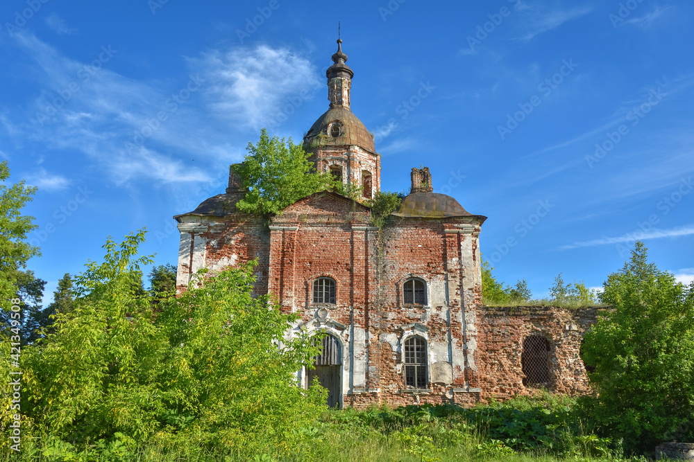 an abandoned dilapidated church, overgrown with grass against the background of the sky, surrounded by greenery an abandoned dilapidated church, overgrown with grass against the background of the sky, surrounded by greenery