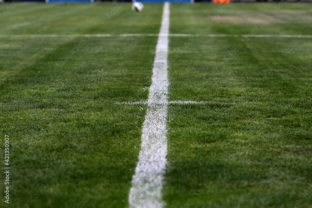 White chalk lines marking a soccer field for playing soccer. Football field with white line markings for the game. Conceptual illustrative editorial view