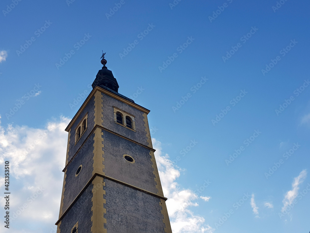 Fototapeta premium Churche tower against blue sky and clouds