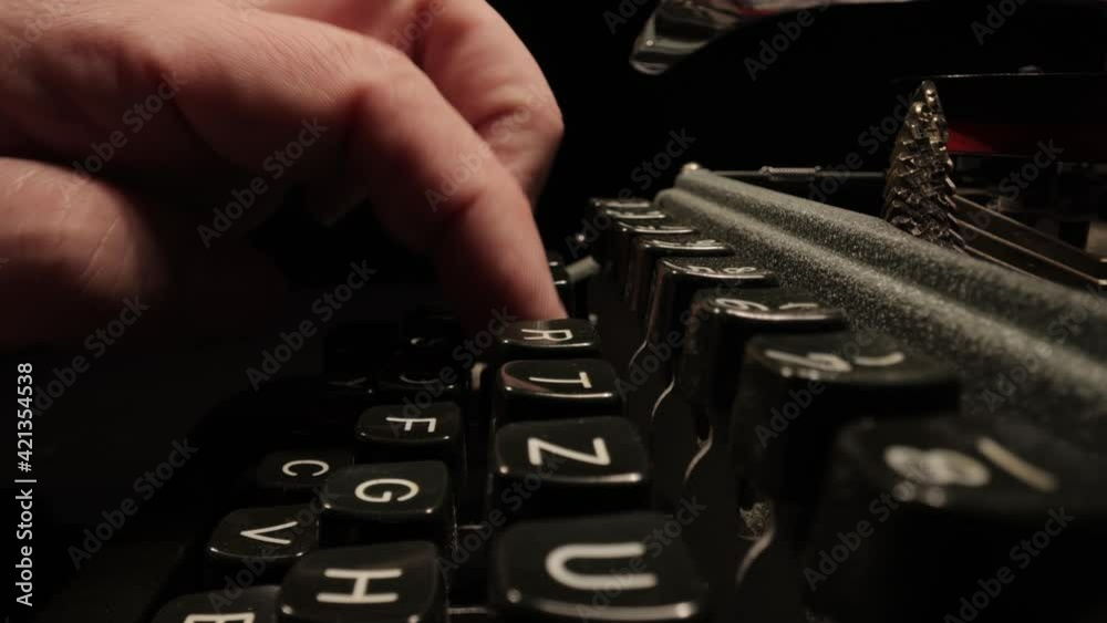 Writing a letter on an old typewriter - very nostalgic - probe lens close up shot