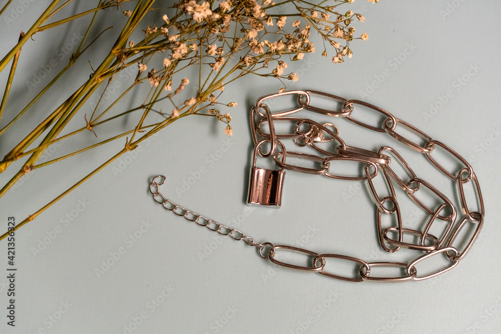 metal chain with a lock and dried flowers metal chain with a lock and dried flowers