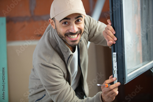 a man drills a wall with a cordless drill photo