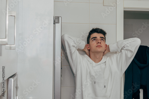 Schilderij op canvas young man at home on the wall leaning pensively