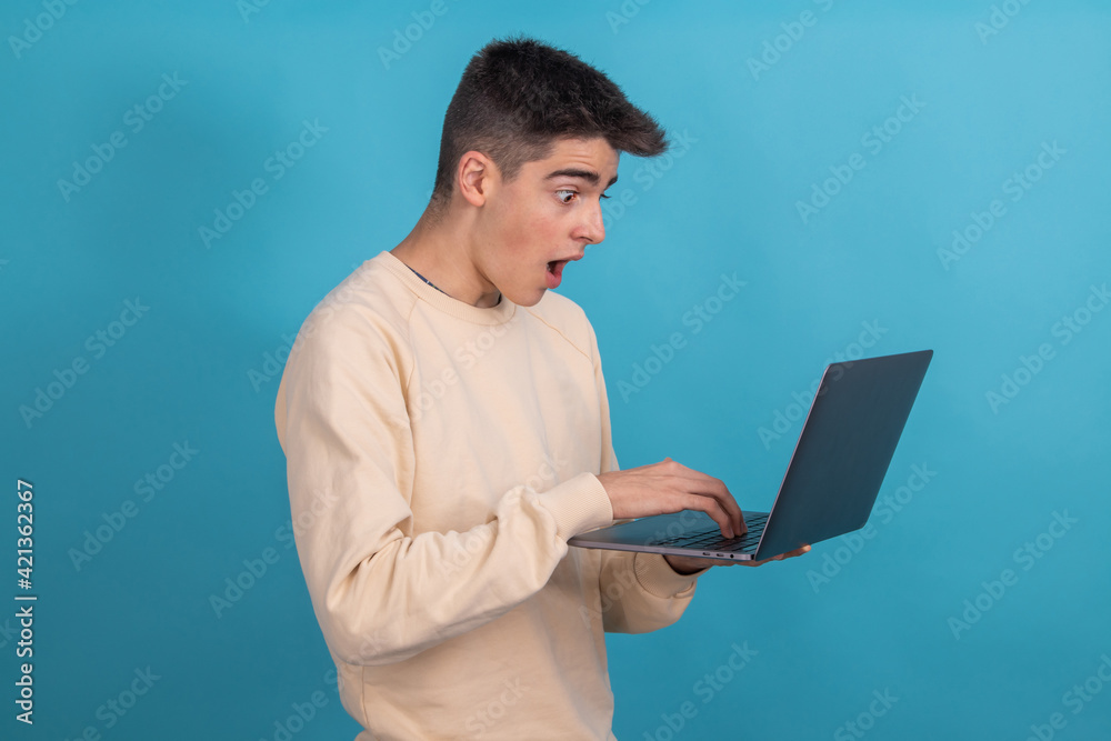 isolated surprised teenager or student with laptop